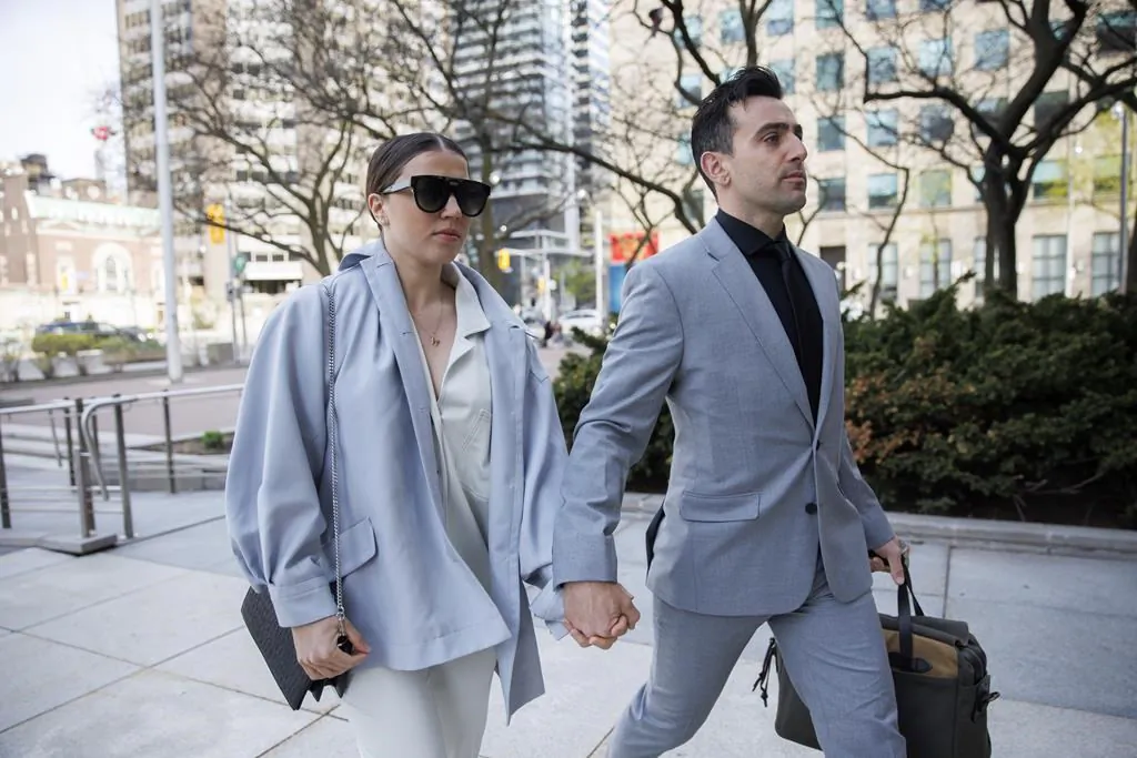 Canadian musician Jacob Hoggard arrives alongside his wife Rebekah Asselstine, for his sex assault trial at a court in Toronto on May 10, 2022. (The Canadian Press/Cole Burston)