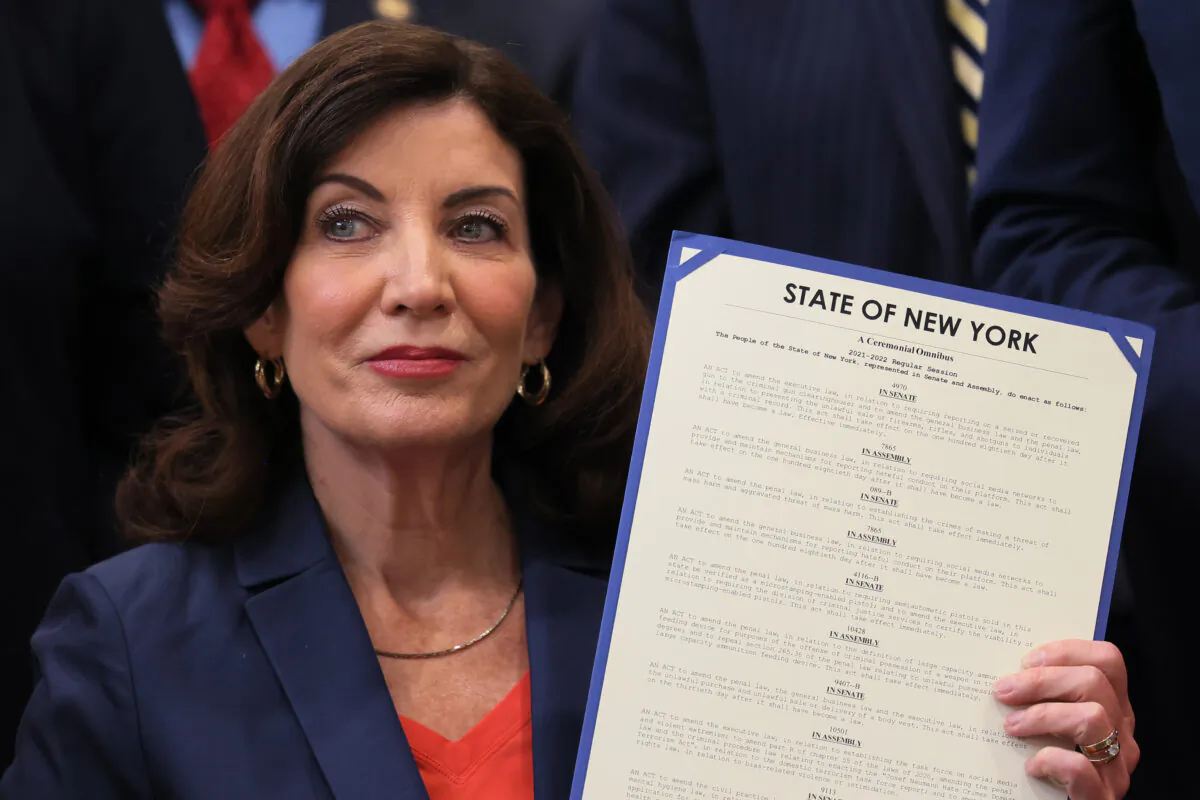 New York Gov. Kathy Hochul holds up signed legislation during a ceremony at the Bronx YMCA in New York City on June 6, 2022. (Michael M. Santiago/Getty Images)
