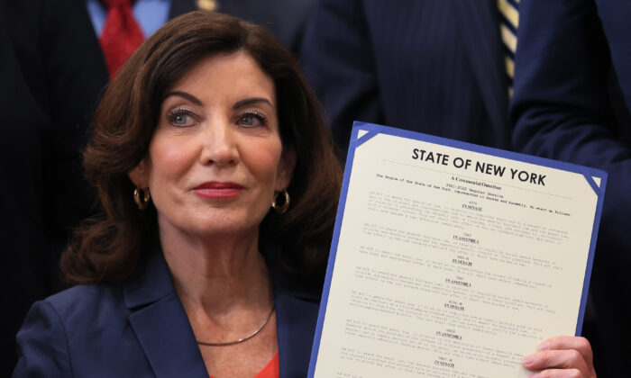 New York Gov. Kathy Hochul holds up signed legislation during a ceremony at the Bronx YMCA in New York City on June 6, 2022. (Michael M. Santiago/Getty Images)