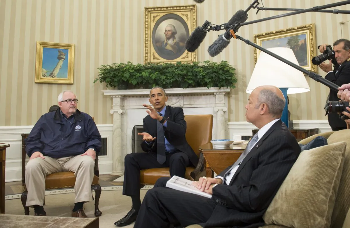 President Barack Obama speaks alongside Secretary of Homeland Security Jeh Johnson (R) following the Presidential Daily Briefing in the Oval Office of the White House in Washington, DC, October 7, 2016. (Saul Loeb/AFP via Getty Images)