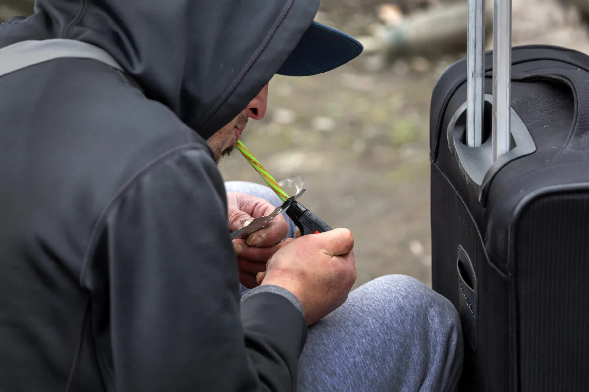 A homeless man  smokes fentanyl in Seattle, Washington, on March 12, 2022. (John Moore/Getty Images)