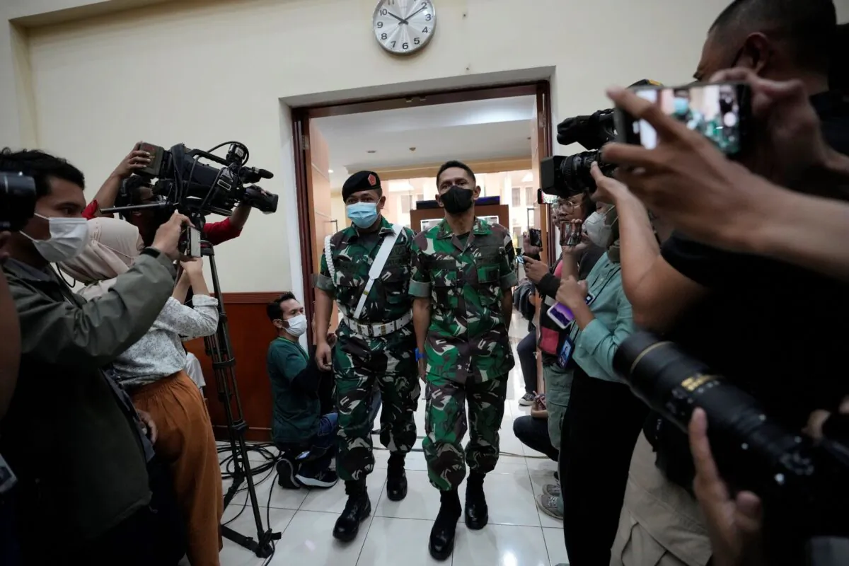 Colonel Priyanto, a mid rank army officer (C), walks in a courtroom before his trial at the local military court in Jakarta, Indonesia on June 7, 2022. (Achmad Ibrahim/AP Photo)