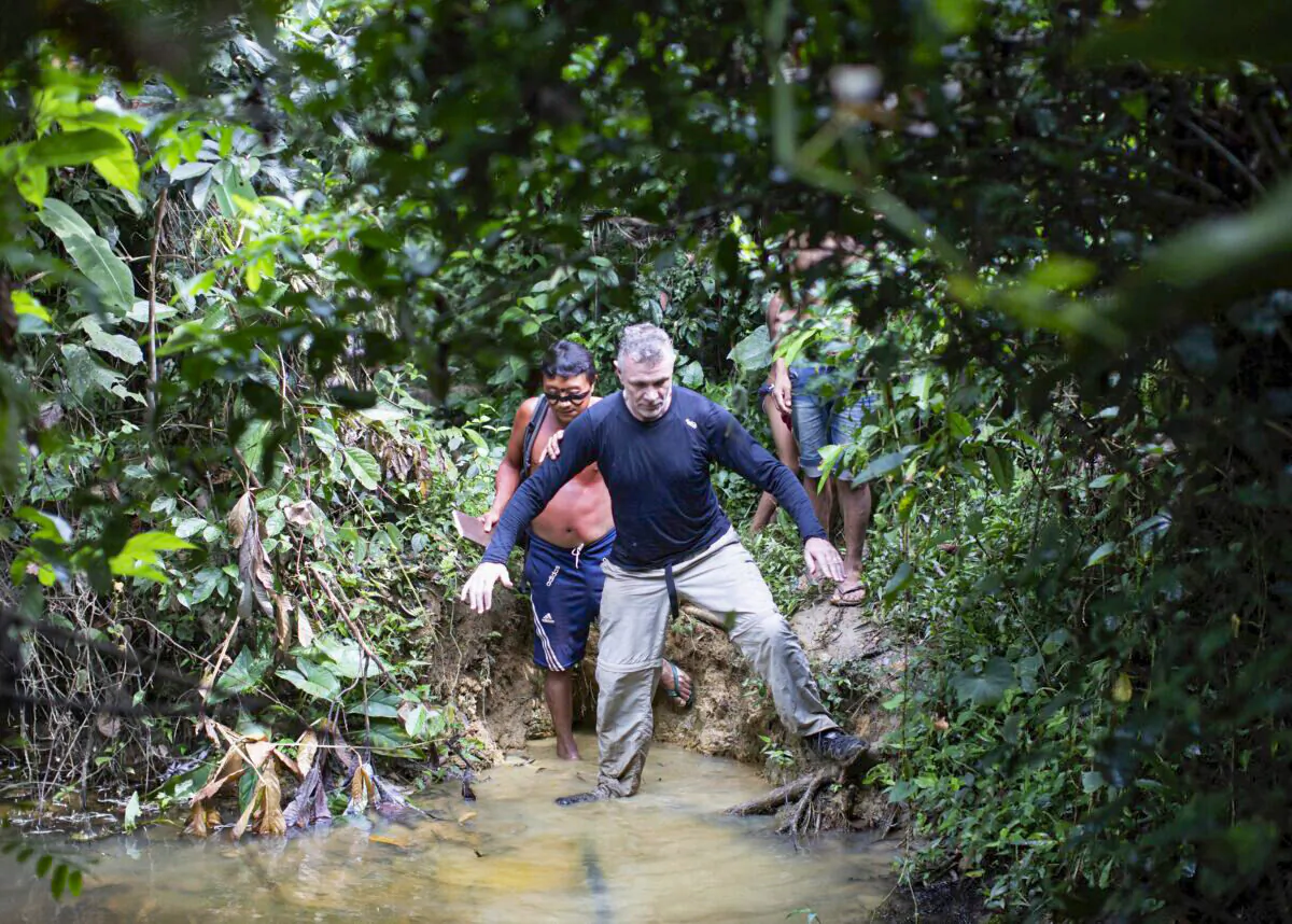 British journalist Dom Phillips (R) and a Yanomami Indigenous man walk in Maloca Papiu village, Roraima state, Brazil, in November 2019. (Joao Laet/AP Photo)