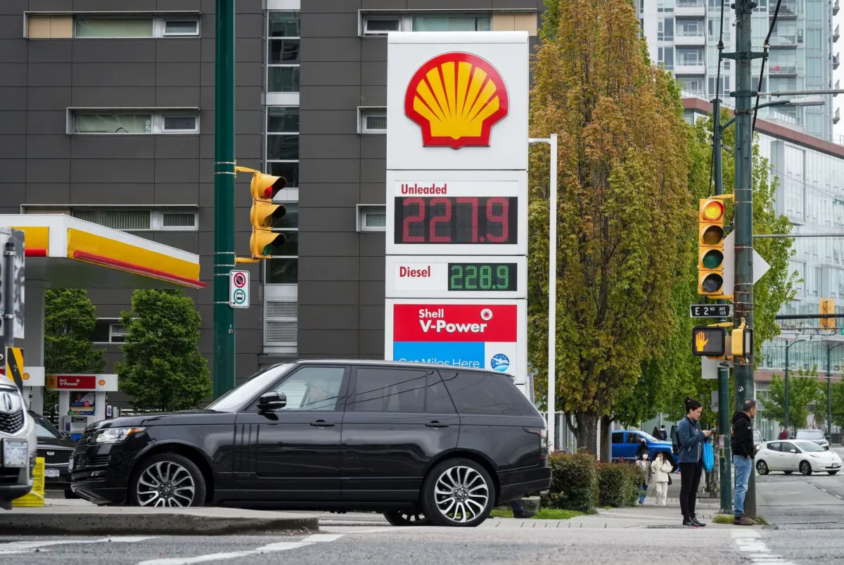 A sign at a gas station in Vancouver displays the price of a litre of regular-grade gasoline after it reached a new high of $2.28, on May 14, 2022. (The Canadian Press/Darryl Dyck)