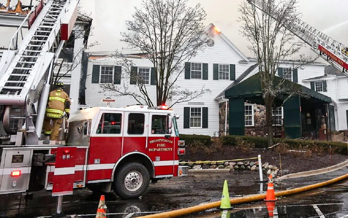 Tower ladders pour water on a massive fire at the Oakland Hills Country Club in Bloomfield Hills, Mich., on Feb. 17, 2022. (Leon Halip/Getty Images)