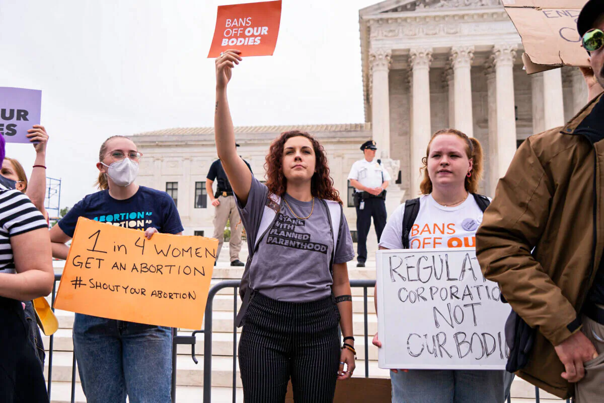 Activists protest in response to the leaked Supreme Court draft decision to overturn Roe v. Wade in front of the U.S. Supreme Court on May 3, 2022. (Louis Chen/The Epoch Times)