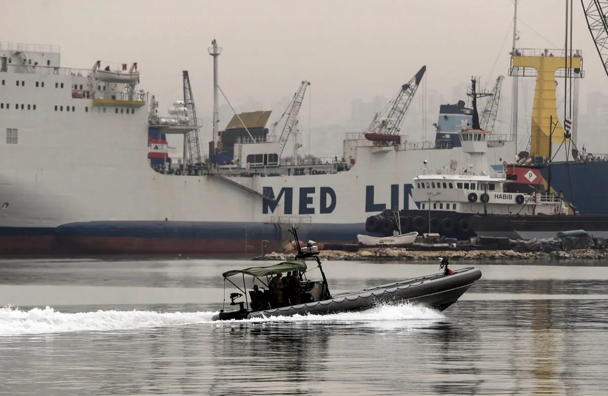 A Lebanese Armed Forces vessel enters the port of Tripoli, allegedly carrying victims from a boat of around 60 migrants, that capsized a day earlier off the coast of the northern city, on April 24, 2022.(Ibrahim Chalhoub/AFP via Getty Images)