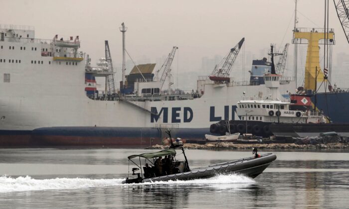 A Lebanese Armed Forces vessel enters the port of Tripoli, allegedly carrying victims from a boat of around 60 migrants, that capsized a day earlier off the coast of the northern city, on April 24, 2022.(Ibrahim Chalhoub/AFP via Getty Images)