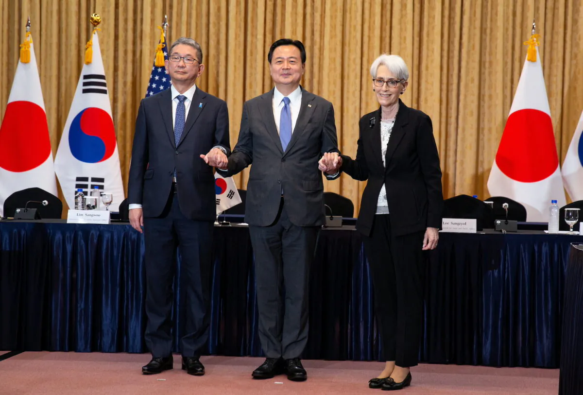 Japan's Vice Minister for Foreign Affairs Takeo Mori, South Korea's First Vice Foreign Minister Cho Hyun-dong and U.S Deputy Secretary of State Wendy Sherman pose for a photo prior their meeting at the Foreign Ministry in Seoul, South Korea, on June 8, 2022. (Jeon Heon-Kyun/Pool via Reuters)