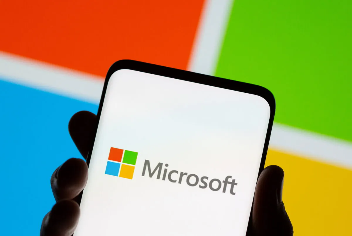 A phone in front of a Microsoft logo displayed in this illustration taken on July 26, 2021. (Dado Ruvic/Reuters)