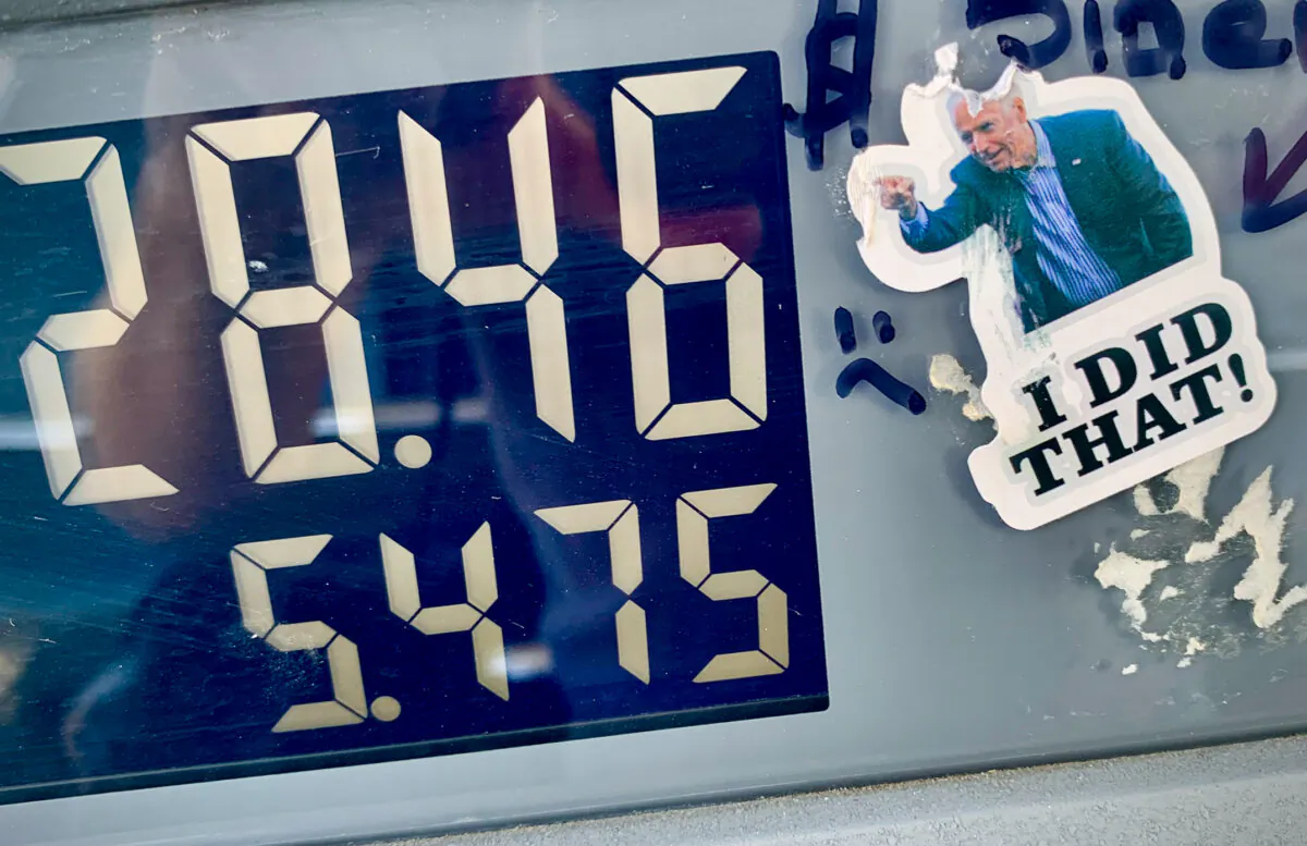 A sticker dipecting President Joe Biden sits on a gas pump in Irvine, Calif., on Nov. 24, 2021. (John Fredricks/The Epoch Times)