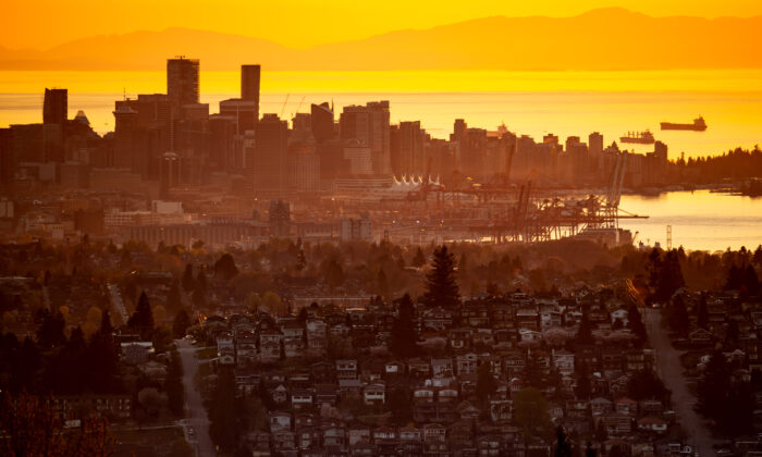 The downtown Vancouver skyline is seen at sunset, as houses line a hillside in Burnaby, B.C., on April 17, 2021. (Darryl Dyck/The Canadian Press)