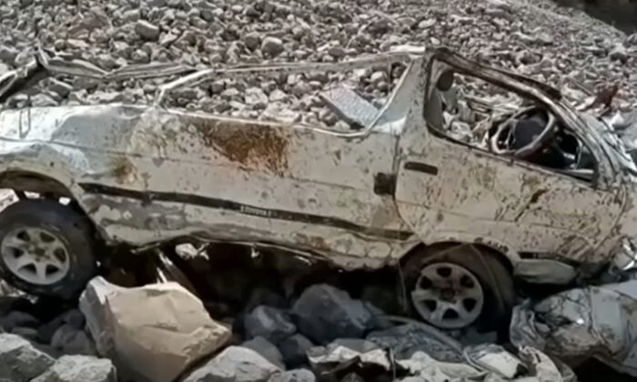 The wreckage of a minibus after it veered off a narrow mountain road and plummeted into a ravine, in Qilla Saifullah, a district in Pakistan's southwest Baluchistan province, on June 8, 2022, in a still from video. (AP/Screenshot via The Epoch Times)