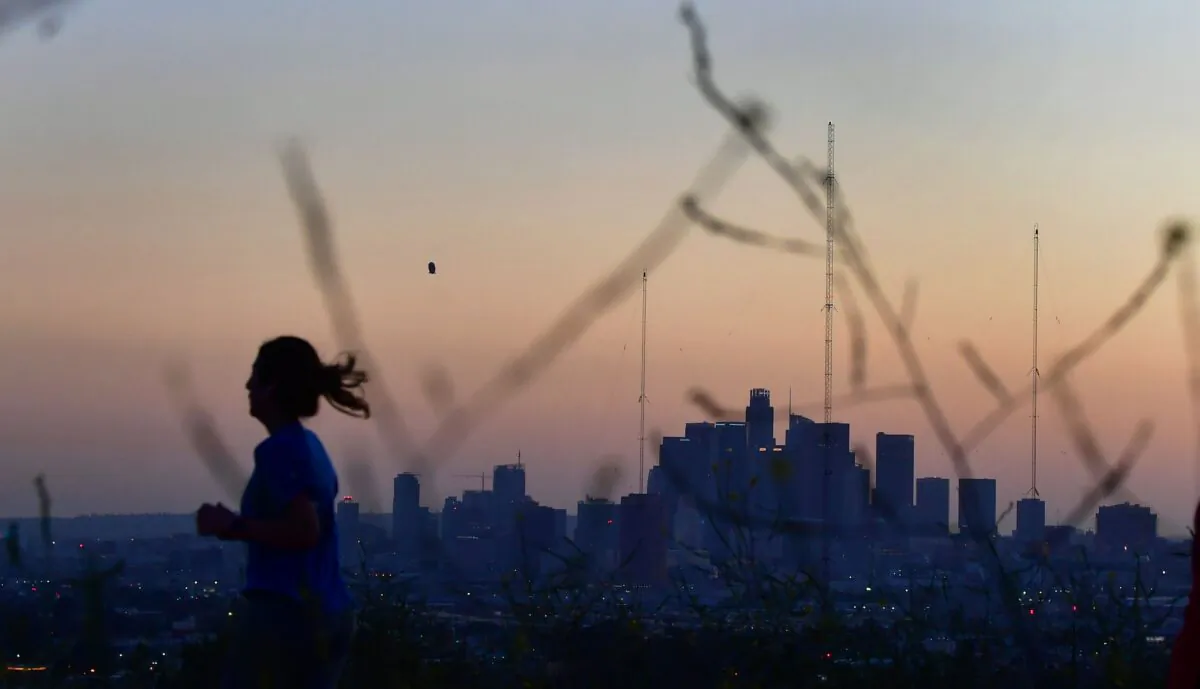 A woman jogs in a park after sunset in Los Angeles on April 6, 2022. (Frederic J. Brown/AFP via Getty Images)