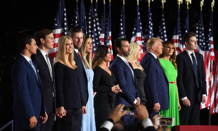 (R–L) Barron Trump, -then-First Lady Melania Trump, then-President Donald Trump, Tiffany Trump, Donald Trump Jr., Kimberly Guilfoyle, Lara Trump, Eric Trump, Ivanka Trump, Jared Kushner, and Michael Boulos stand after the president delivered his acceptance speech for the Republican Party nomination for reelection during the final day of the Republican National Convention at the South Lawn of the White House on Aug. 27, 2020. (Saul Loeb/AFP via Getty Images)