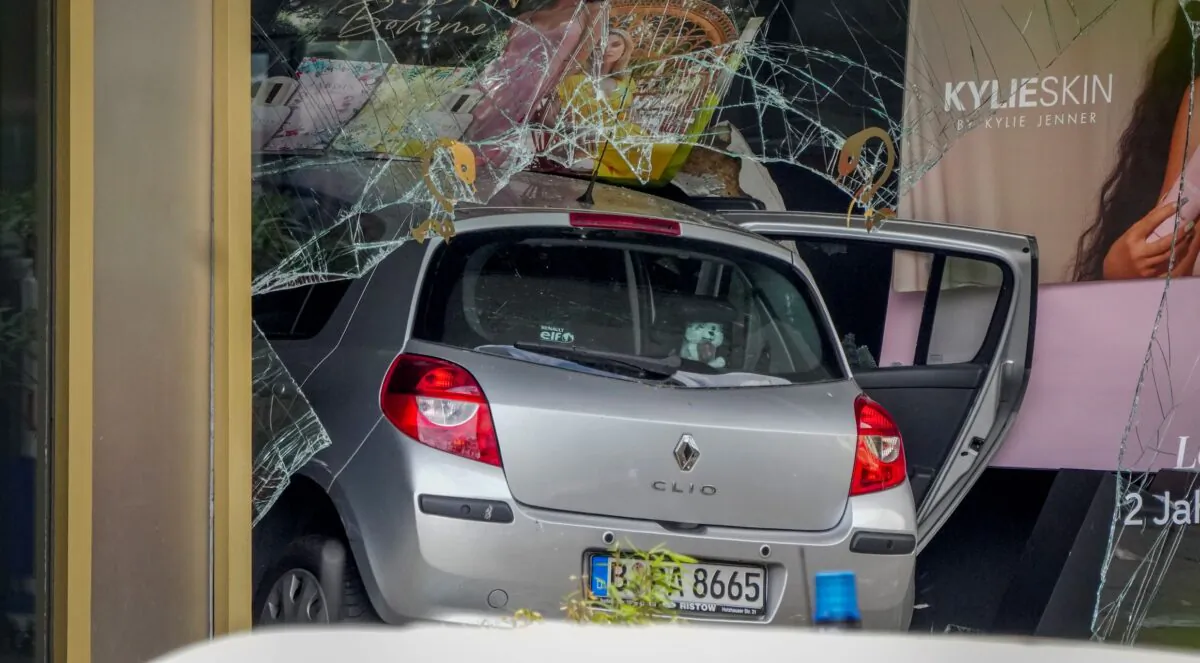 A car crashed into a store after crashing into a crowd of people in central Berlin, on June 8, 2022. (Michael Sohn/AP Photo)