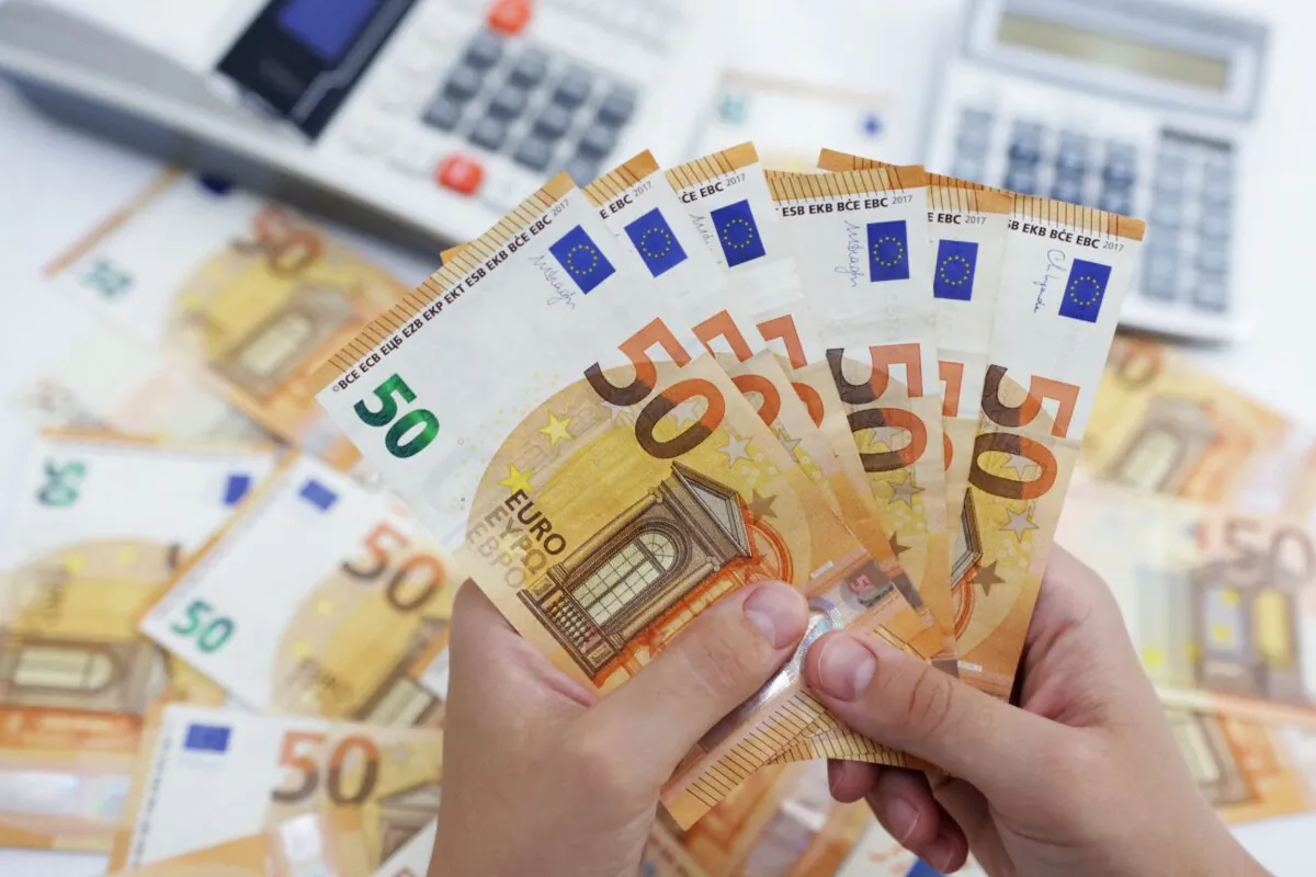 A woman holds Euro banknotes in this illustration taken on May 30, 2022. (Dado Ruvic/Illustration/Reuters)