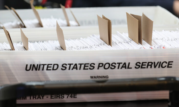 Boxes for Vote-by-Mail ballots that need to be reviewed due to signature discrepancies, as the Miami-Dade County Canvassing Board convenes ahead of the November 3rd general election at the Miami-Dade County Elections Department in Doral, Fla., on Oct. 15, 2020. (Joe Raedle/Getty Images)