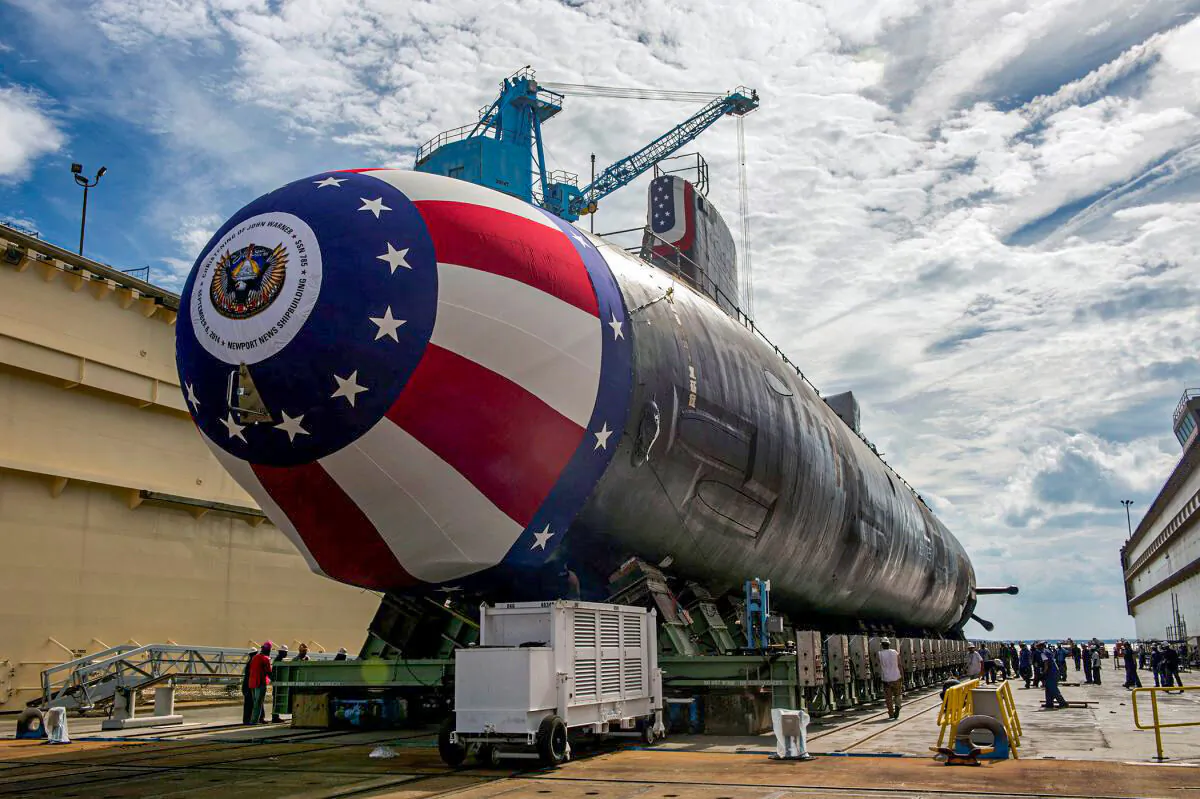 The Virginia-class attack submarine Pre-commissioning Unit (PCU) John Warner (SSN 785) is moved to Newport News Shipbuilding's floating dry dock in preparation for the September 6 christening in Newport News, Virginia, U.S. August 31, 2014. U.S. Navy/John Whalen/Huntington Ingalls Industries/Handout via REUTERS