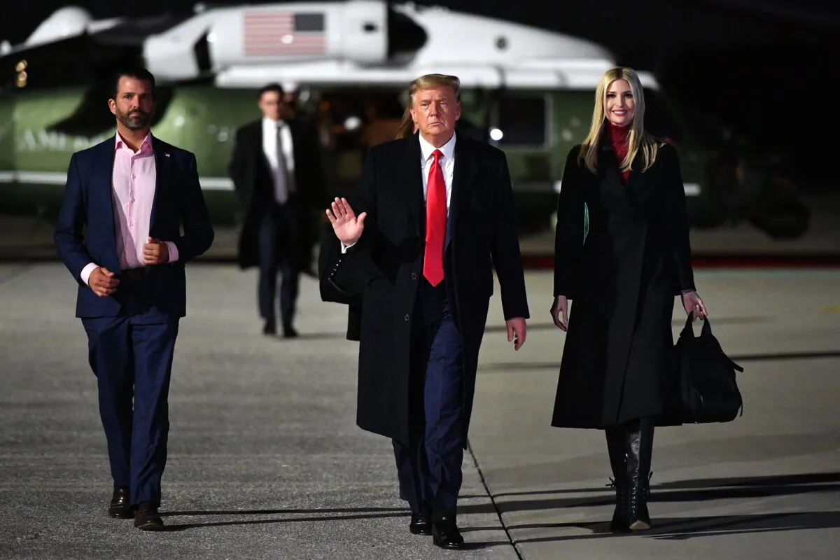 Donald Trump, who was then-U.S. president, daughter Ivanka Trump, and son Donald Trump Jr., make their way to board Air Force One before departing from Dobbins Air Reserve Base in Marietta, Georgia on Jan. 4, 2021. (Mandel Ngan/AFP via Getty Images)