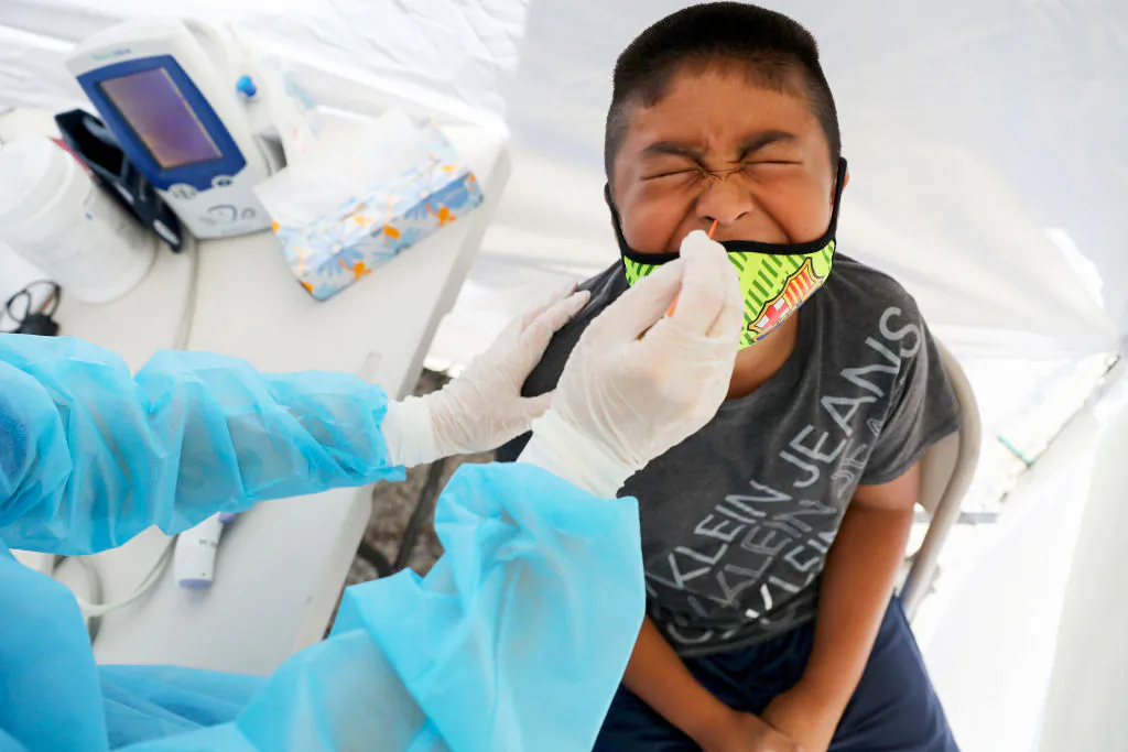 A boy receives a free COVID-19 test at a St. John’s Well Child & Family Center mobile clinic set up outside Walker Temple AME Church in South Los Angeles amid the coronavirus pandemic in Los Angeles on July 15, 2020. (Mario Tama/Getty Images)