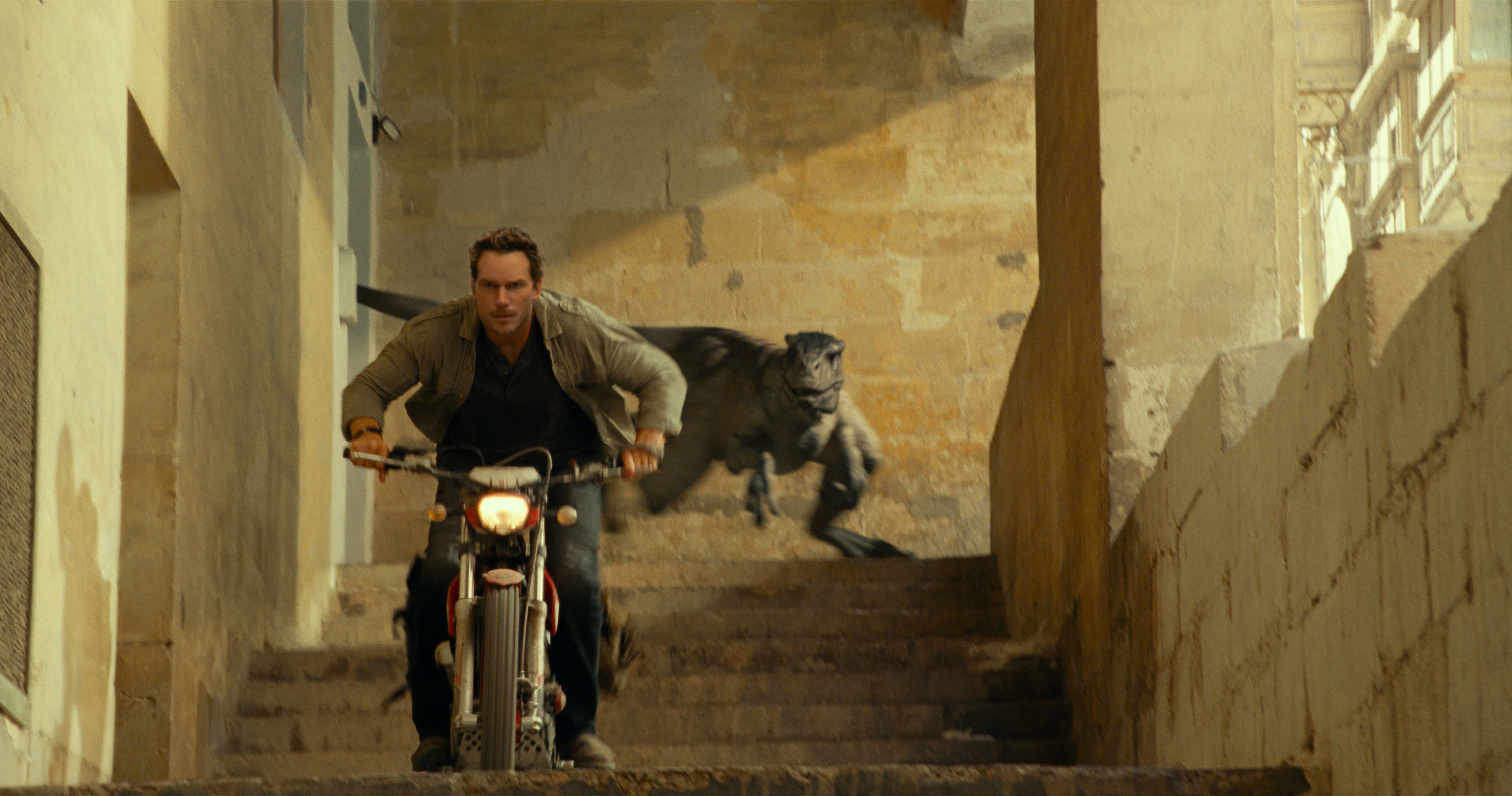 man on motorcycle and dinosaur in Jurassic World: Dominion