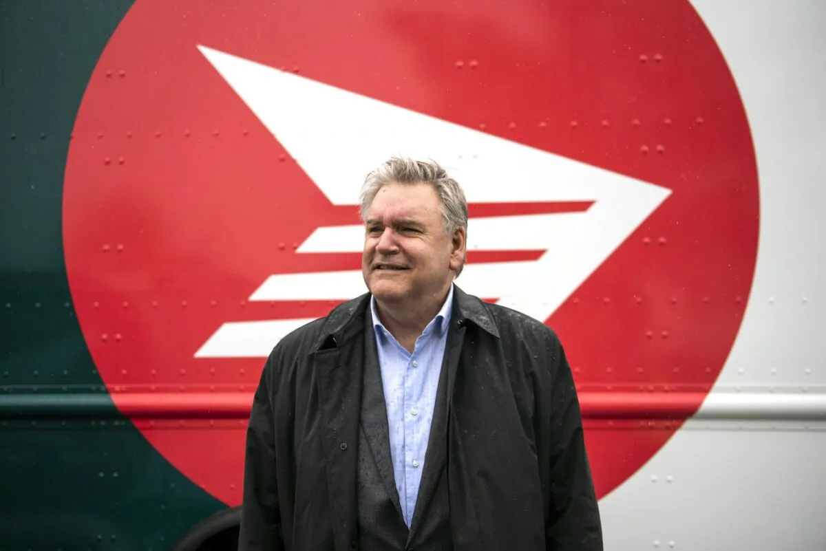 Canada Post CEO Doug Ettinger poses in front of an electric delivery vehicle after a news conference on the postal service’s plans to transform their fleet of 14,000 vehicles, in Ottawa, on June 9, 2022. (The Canadian Press/Justin Tang)