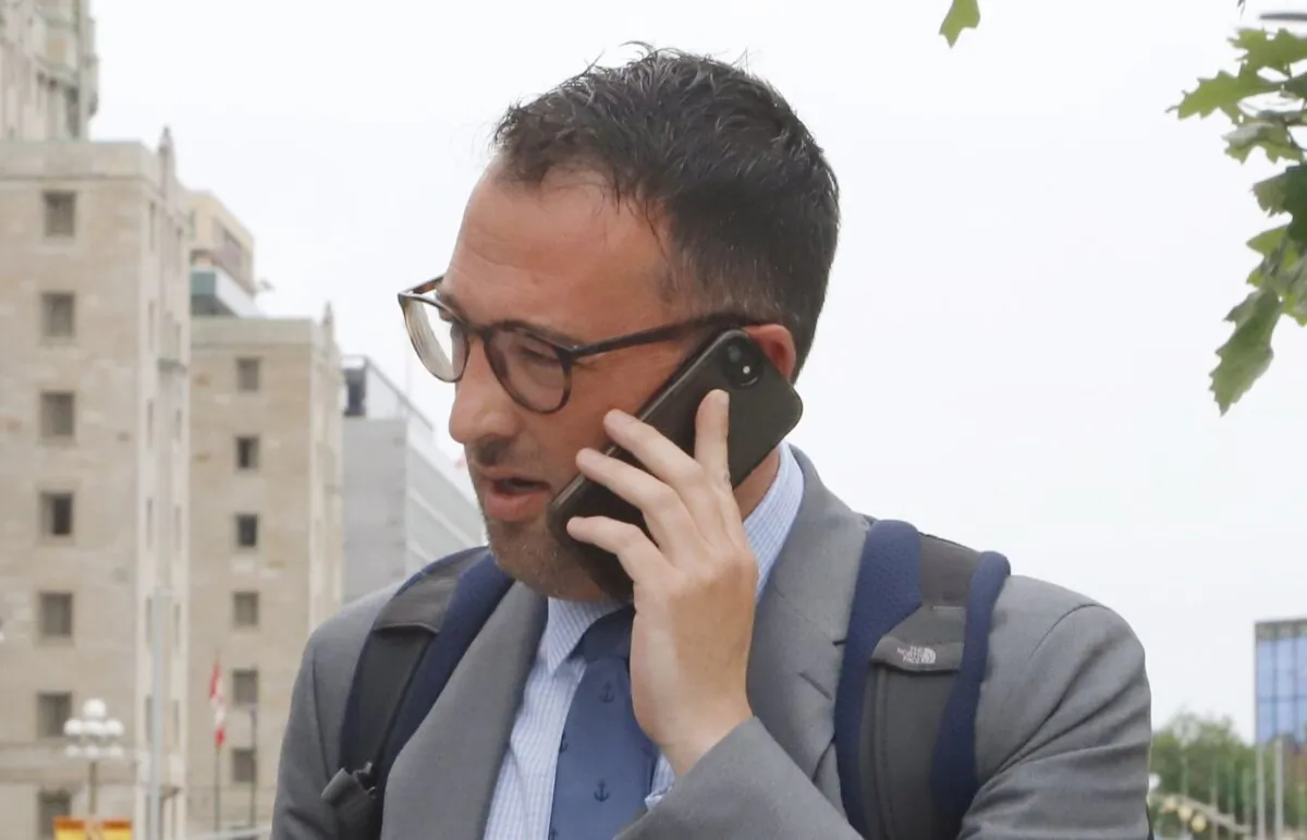 Matthew Matchett, a federal public servant charged with one count of breach of trust for allegedly leaking secret cabinet documents about a contract between the federal government and Chantier Davie shipyard, leaves the Ottawa courthouse during a break in his trial on June 6, 2022. (The Canadian Press/ Patrick Doyle)