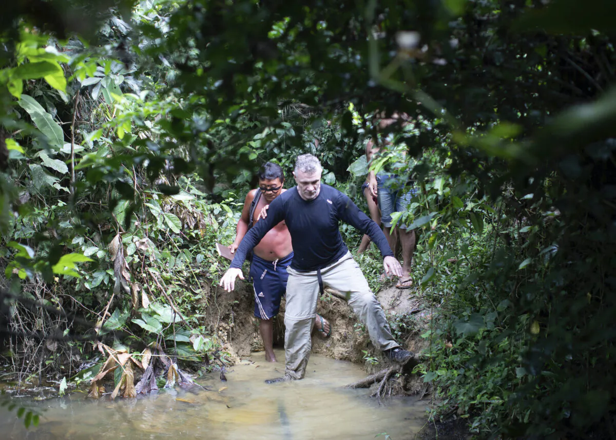 British journalist Dom Phillips (R), and a Yanomami indigenous man walk in Maloca Papiu village, Roraima state, Brazil, in Nov. 2019. (Joao Laet/AP Photo)