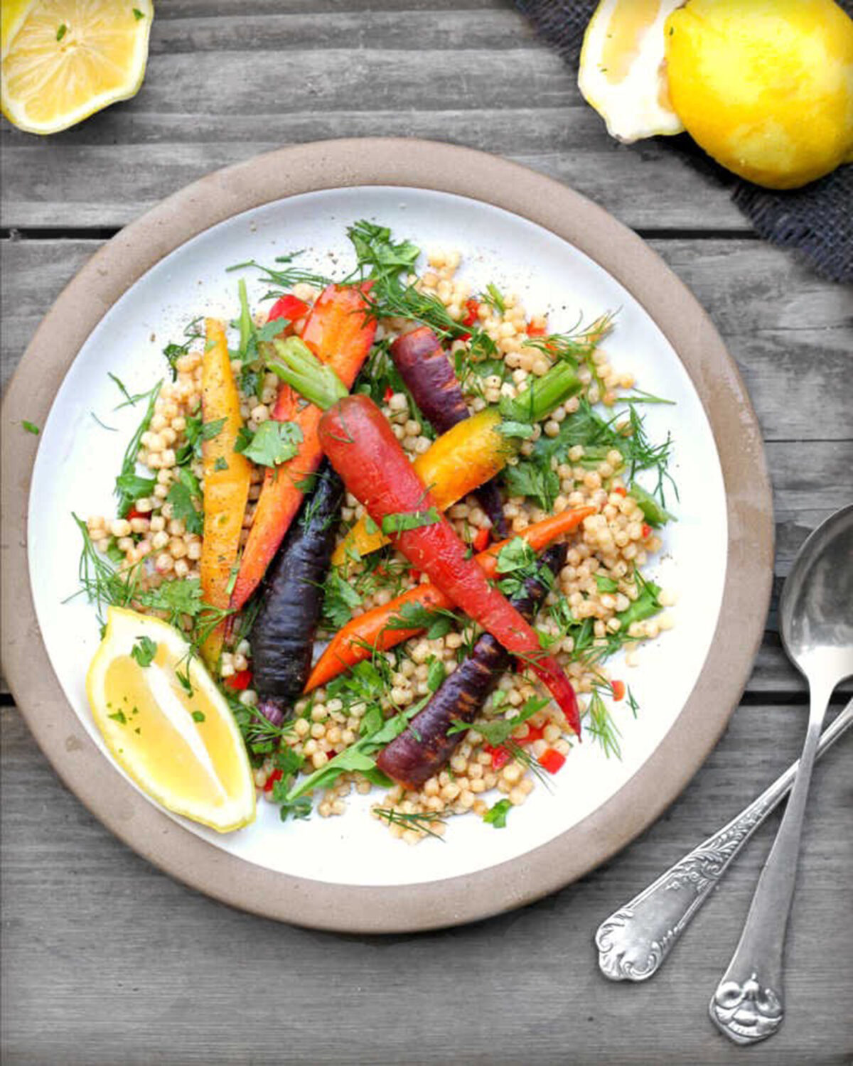 Roasted summer carrots, sweet and bright, are accompanied by frilly herbs and nutty Israeli couscous in this versatile salad. (Lynda Balslev for Tastefood)