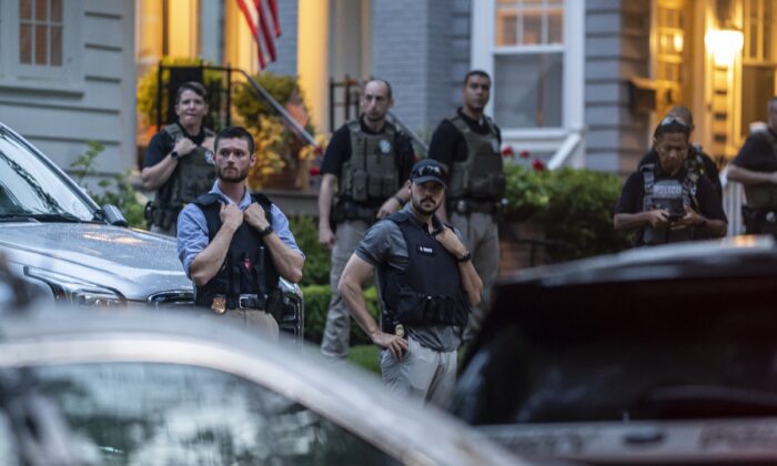 Law enforcement officers stand guard as protesters march past Supreme Court Justice Brett Kavanaugh's home in Chevy Chase, Md., on June 8, 2022. (Nathan Howard/Getty Images)
