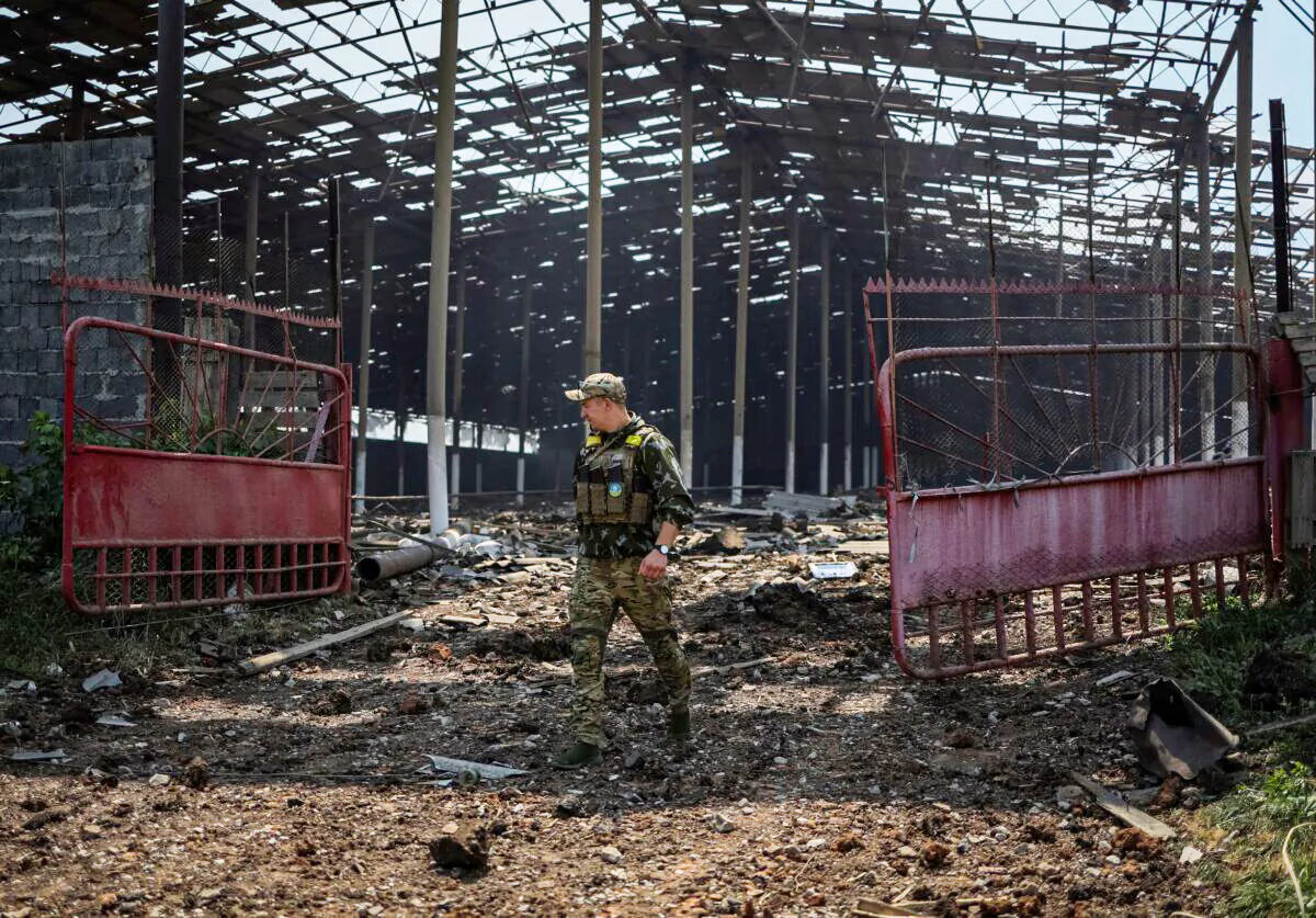 A Ukrainian serviceman walks in a destroyed grain silos after a morning strike, near the town of Soledar, Donetsk region, Ukraine, on June 8, 2022. (Gleb Garanich/Reuters)