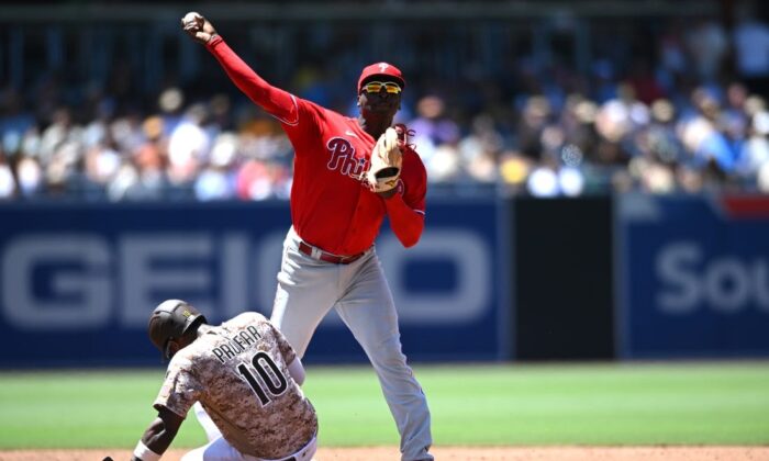 Philadelphia Phillies shortstop Didi Gregorius (top) throws to first base late after forcing out San Diego Padres left fielder Jurickson Profar (10) at second base during the third inning at Petco Park in San Diego on June 26, 2022. (Orlando Ramirez/USA TODAY Sports via Field Level Media)
