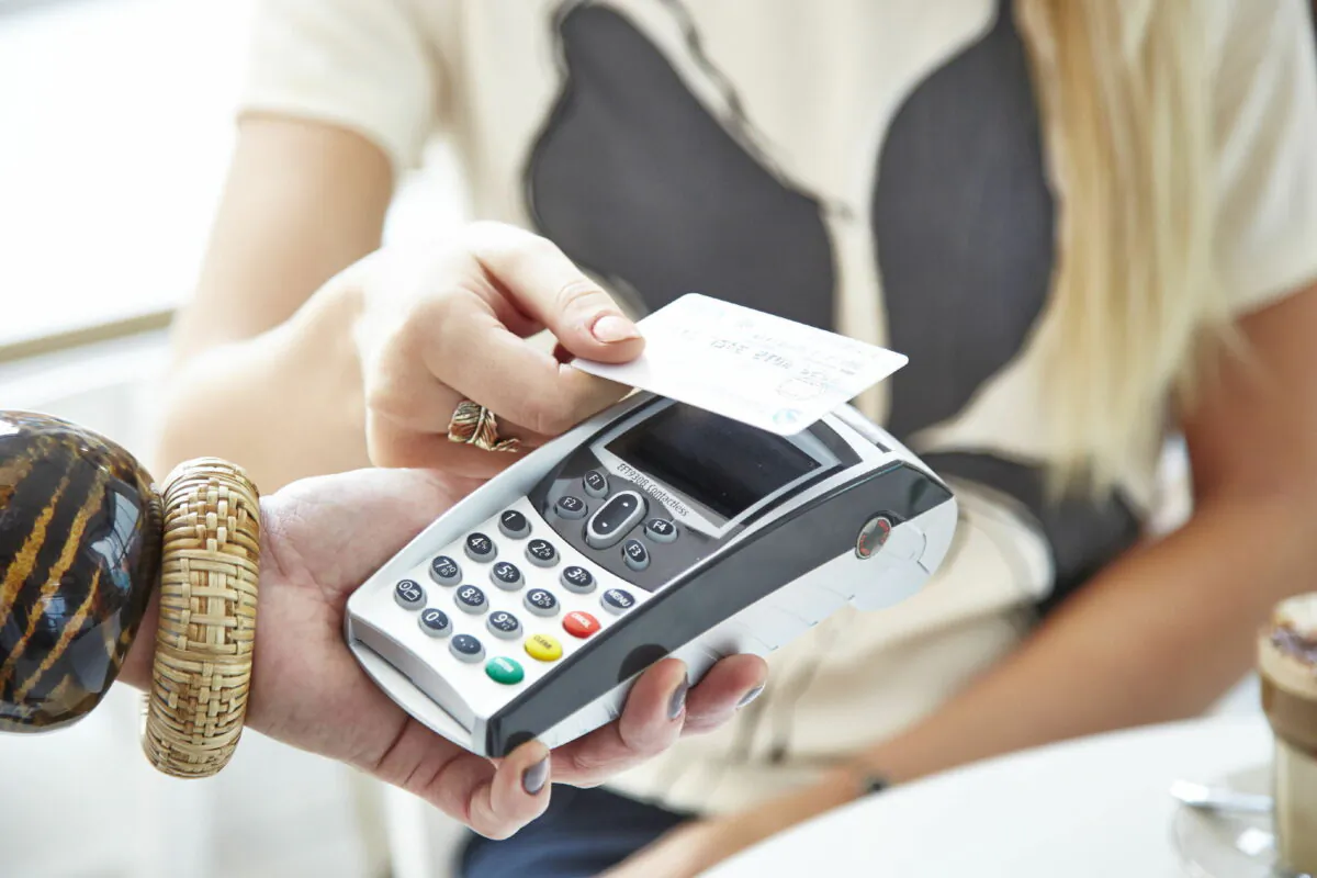 Undated file photo showing a customer using a credit card. (Barclaycard/PA Media)