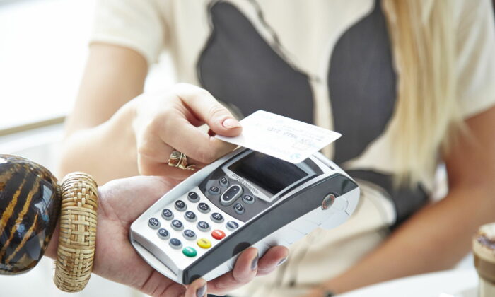 Undated file photo showing a customer using a credit card. (Barclaycard/PA Media)
