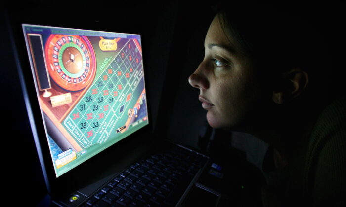 Undated photo of a woman at a computer that displays an online gambling game. (Joel Ryan/PA Media)