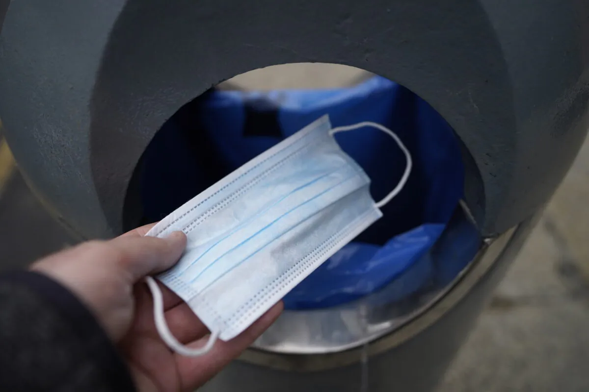Undated photo showing a mask being binned. (Niall Carson/PA Media)
