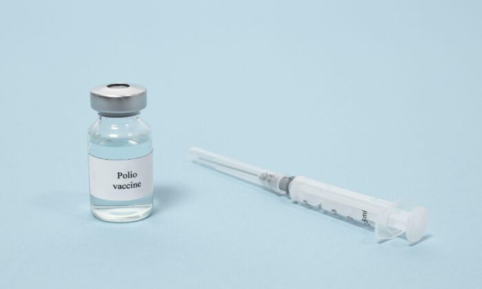 A illustration photo showing a syringe and a bottle labeled "Polio vaccine." (Alamy/PA Media)