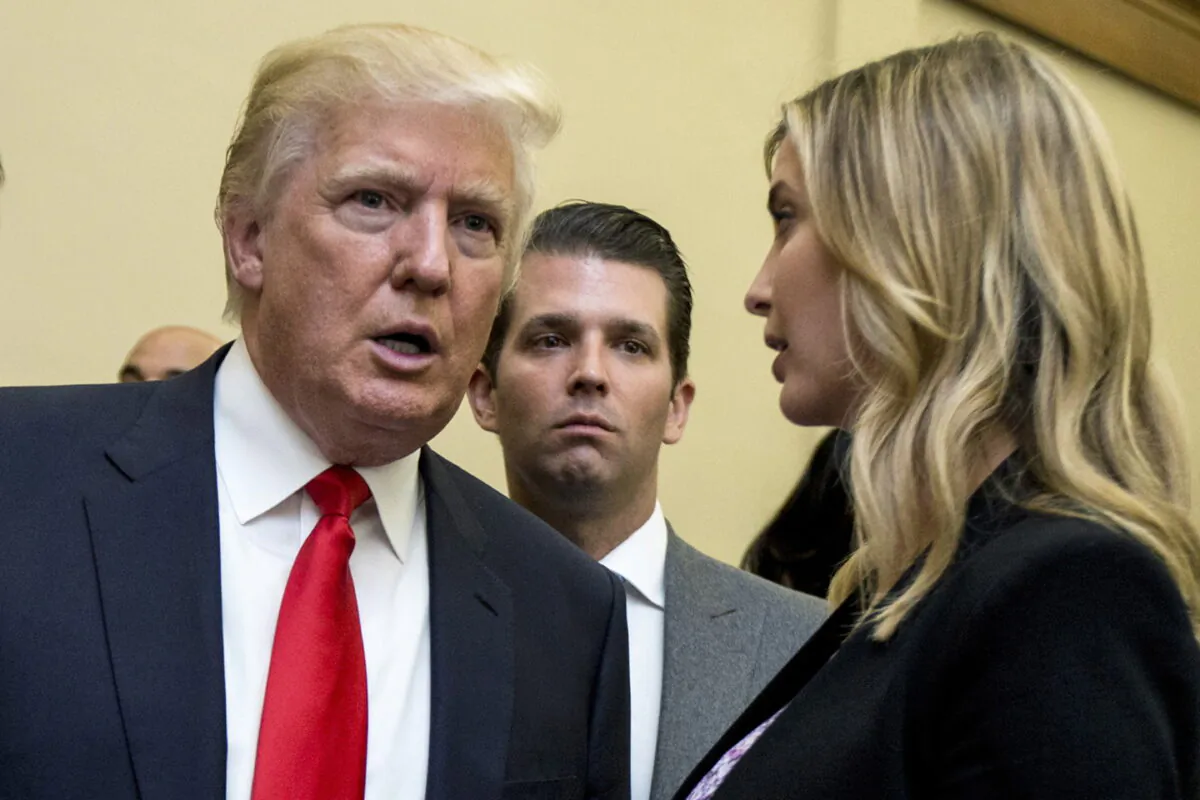 (L–R) Donald Trump, his son Donald Trump Jr., and his daughter Ivanka Trump speak during the unveiling of the design for the Trump International Hotel in the The Old Post Office in Washington on Sept. 10, 2013. (Manuel Balce Ceneta/AP Photo)
