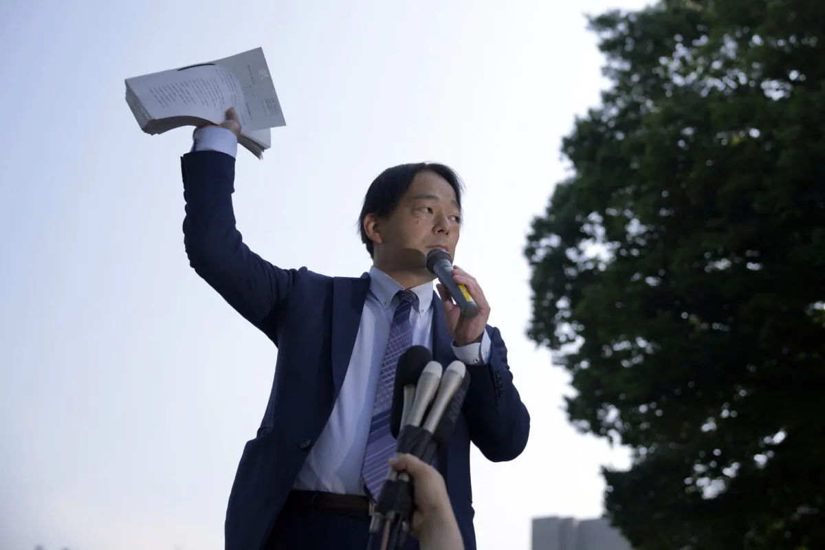 Izutaro Managi, a lawyer for the plaintiffs, speaks to plaintiffs and their supporters after hearing the decision of the Tokyo Supreme Court in Tokyo on June 17, 2022. (Eugene Hoshiko/AP Photo)