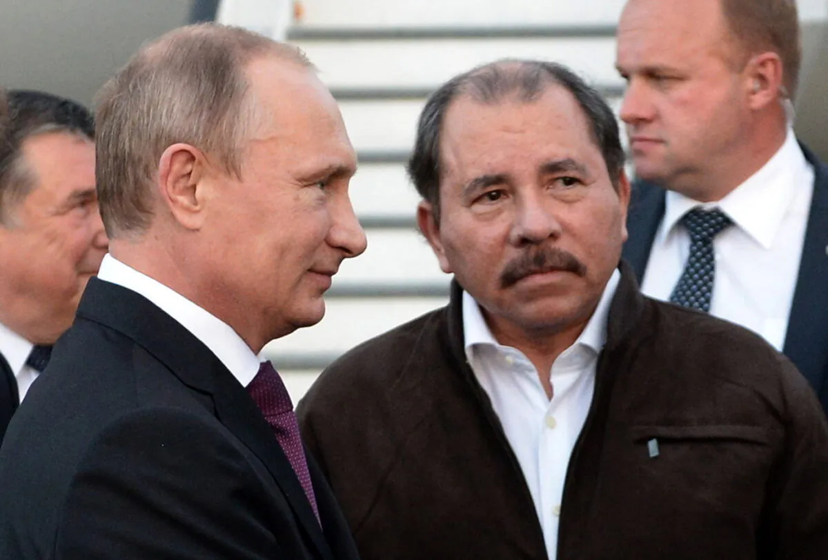 Nicaragua's President Daniel Ortega (R) and Russian President Vladimir Putin (L) attend a welcome ceremony at an airport in Managua, Nicaragua, on July 11, 2014. (RIA-Novosti/Alexei Nikolsky, Presidential Press Service/AP Photo)