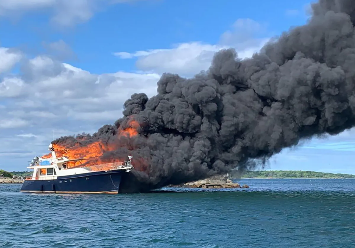 A yacht is burning on the Piscataqua River in New Castle, N.H., on June 18, 2022. (New Hampshire State Police via AP)