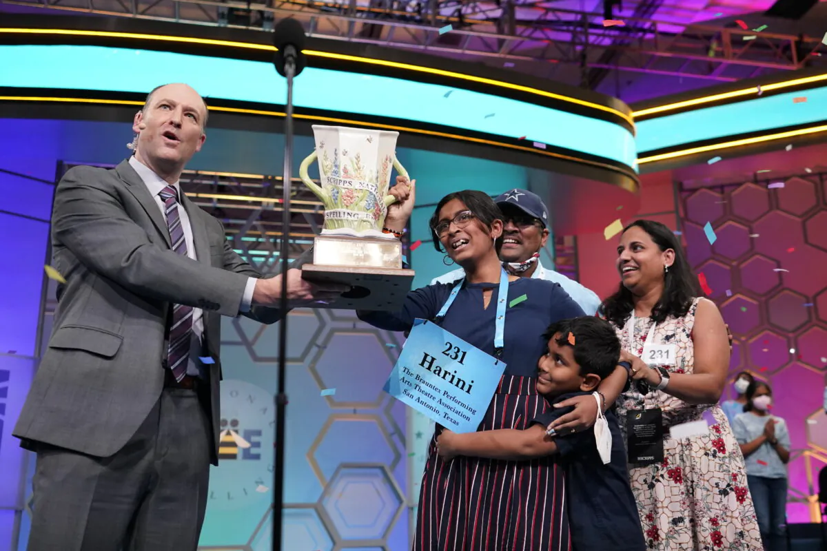 Harini Logan, 14, from San Antonio, Texas, celebrates winning the Scripps National Spelling Bee with Scripps CEO Adam Sampson right and family stage, in Oxon Hill, Md., on June 2, 2022. (Alex Brandon/AP Photo)