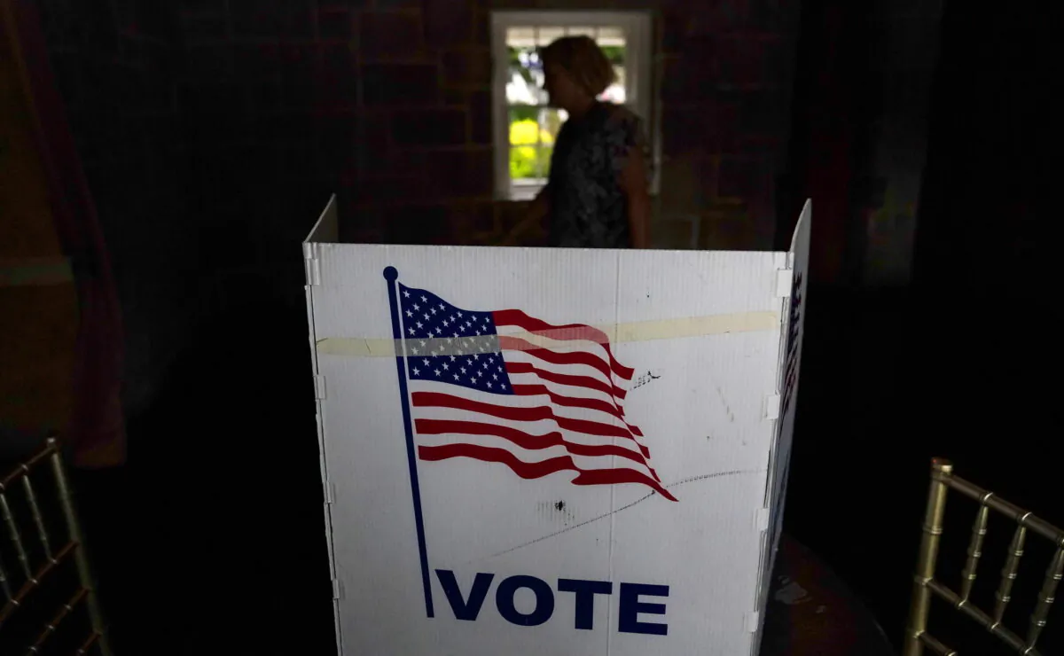 FILE - A person waits in line to vote in the Georgia's primary election on May 24, 2022, in Atlanta. More than 1 million voters across 43 states have switched to the Republican Party over the last year, according to voter registration data analyzed by The Associated Press. (AP Photo/Brynn Anderson, File)
