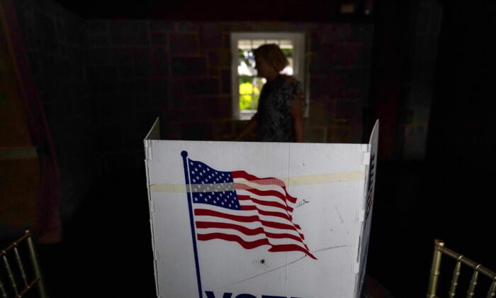A person waits in line to vote in the Georgia's primary election on May 24, 2022, in Atlanta. More than 1 million voters across 43 states have switched to the Republican Party over the last year, according to voter registration data analyzed by The Associated Press. (AP Photo/Brynn Anderson, File)