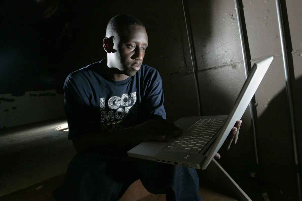 Record producer Chaka Zulu looks through material, created by his artists, to post to YouTube in Atlanta on Sept. 2, 2008. (John Amis/AP Photo)