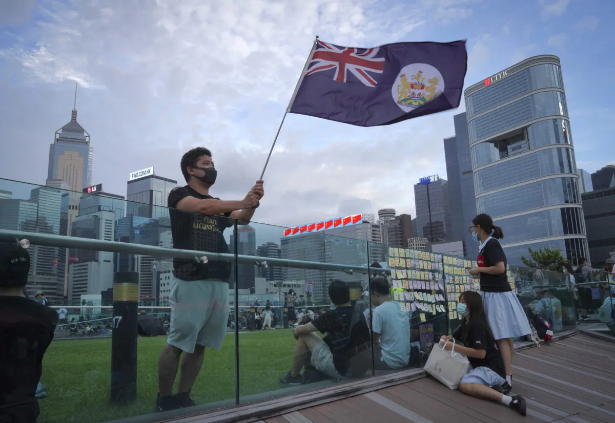 A protester waves Hong Kong British colony flag during continuing pro-democracy rallies in Tamar Park, Hong Kong, on Sept. 3, 2019. (Vincent Yu/AP Photo)