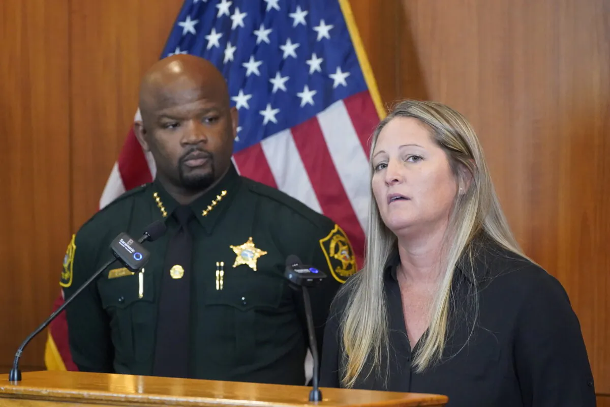 Broward Sheriff's Office Cold Case Unit Sgt. Kami Floyd, right, speaks as Sheriff Gregory Tony looks on during a news conference, at the BSO Public Safety Building in Fort Lauderdale, Fla., on June 7, 2022. (Wilfredo Lee/AP Photo)