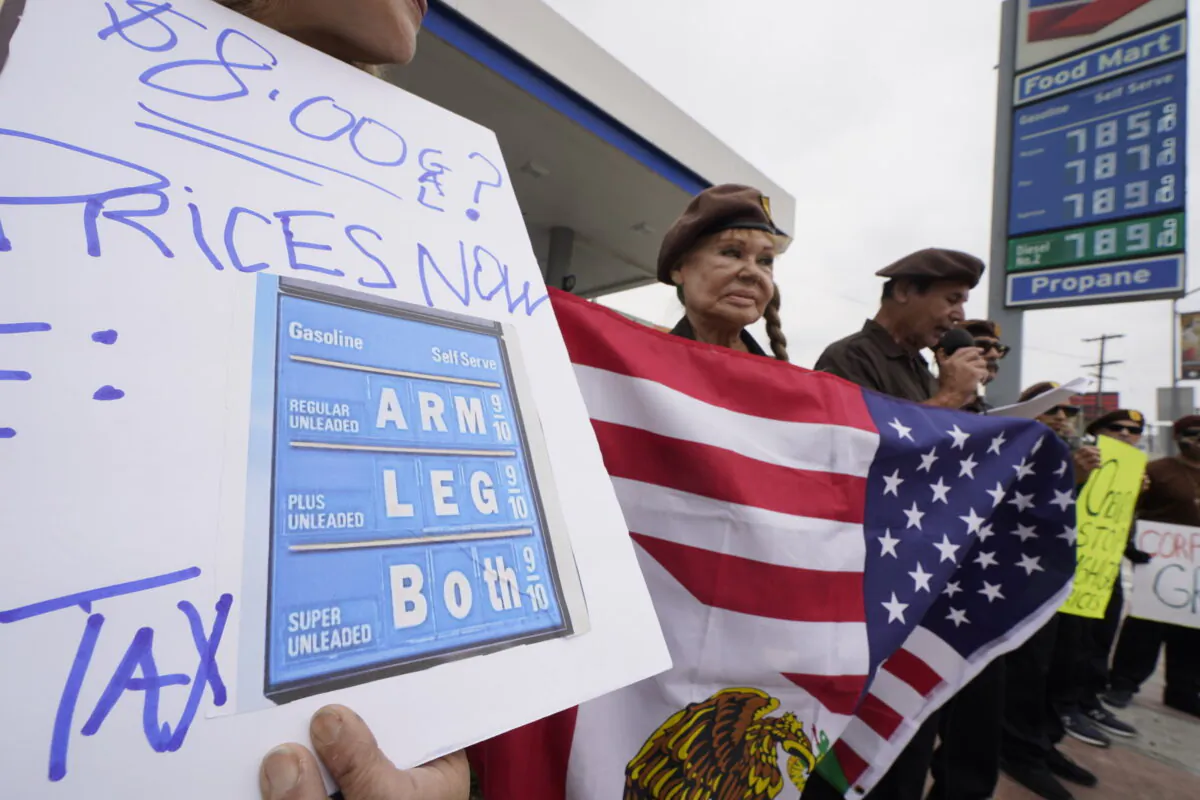 Members of the Brown Beret National Party protest high gasoline prices at a Chevron gas station downtown Los Angeles on June 4, 2022. (Damian Dovarganes/AP Photo)