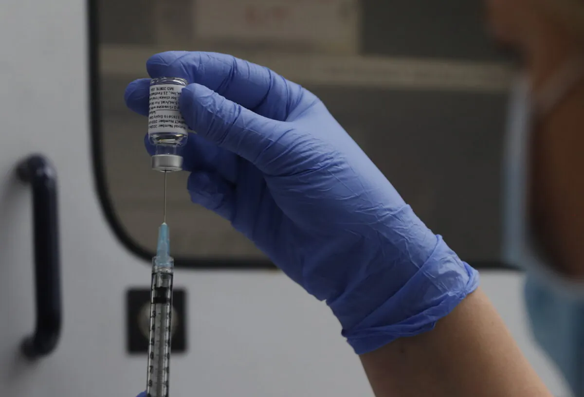 A vial of the Phase 3 Novavax coronavirus vaccine is seen ready for use in the trial at St. George's University hospital in London, Oct. 7, 2020. (AP Photo/Alastair Grant, File)
